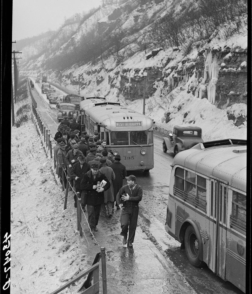Steelworkers walking to the Jones and Laughlin works past a streetcar marked West Aliquippa, January 1941