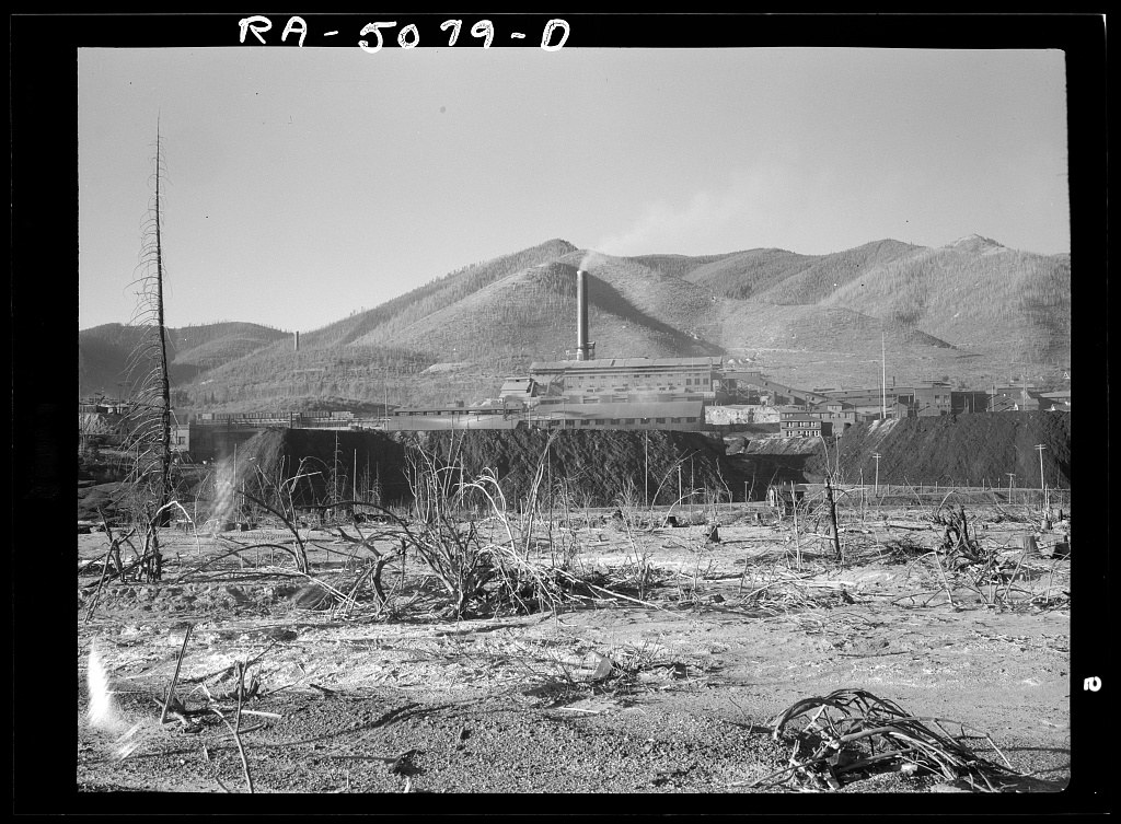 The Bunker Hill smelter at Kellogg, Idaho in 1936, the ground around it stripped of trees